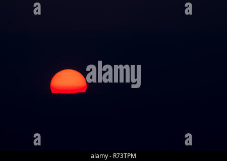 Setting sun and cloud isolated on black for text or copy. Stock Photo