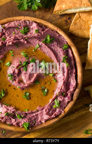 Homemade Purple Hummus with Olive Oil and Pita Chips Stock Photo