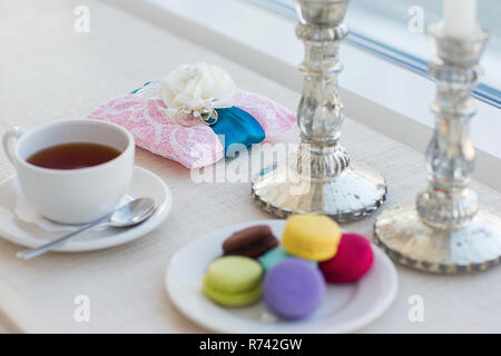 luxary wedding rings with macaroons near window Stock Photo