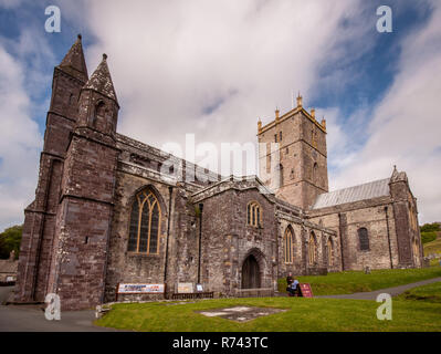 St David's, Wales, UK - May 18, 2009: Tourists walk around the grounds of St David's Cathedral in Britain's smallest city. Stock Photo