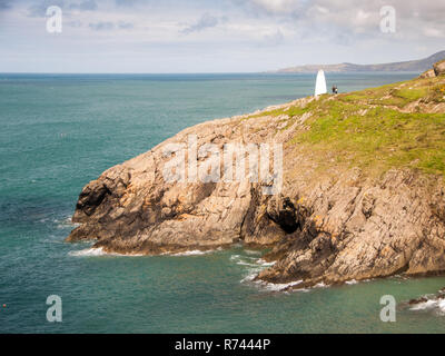 A cairn marks the entrance to Porthgain Harbour on the Pembrokeshire Coast National Park in West Wales. Stock Photo