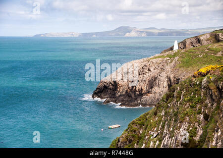 A cairn marks the entrance to Porthgain Harbour on the Pembrokeshire Coast National Park in West Wales. Stock Photo