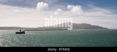 Holyhead Mountain and the long breakwater of Holyhead Harbour in north Wales, seen from Holyhead Bay in the Irish Sea. Stock Photo