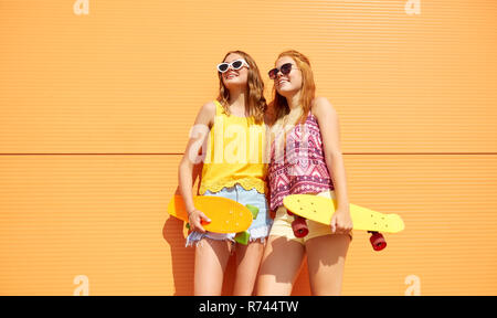 teenage girls with short skateboards outdoors Stock Photo
