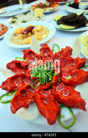 Traditional Turkish food 'Raw Meat' (Cig Kofte) in the restaurant table in Antakya, Turkey. Stock Photo