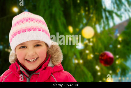 happy little girl in winter clothes outdoors Stock Photo