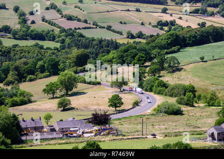 Buxton, England, UK - July 2, 2018: A tanker lorry travels along the A5004 road through the Goyt Valley under the moors of Derbyshire's Peak District. Stock Photo