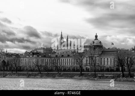 Vltava river bank, amazing and quiet view of Prague, with a bright sky partially cloudy, focus on the Castle area, black and white, horizontal Stock Photo