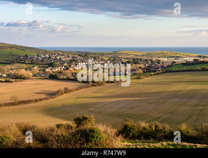 Houses of the village of Osmington are nestled amongst farm fields in a valley in the Dorset Downs hills, beside the English Channel's Jurassic Coast. Stock Photo