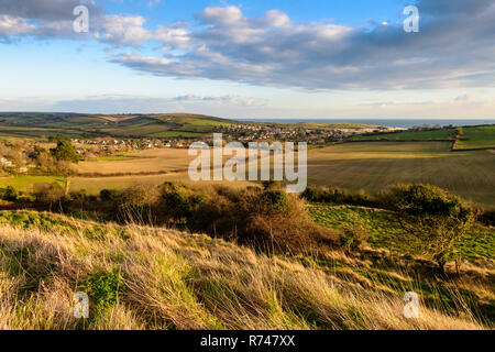 Houses of the village of Osmington are nestled amongst farm fields in a valley in the Dorset Downs hills, beside the English Channel's Jurassic Coast. Stock Photo