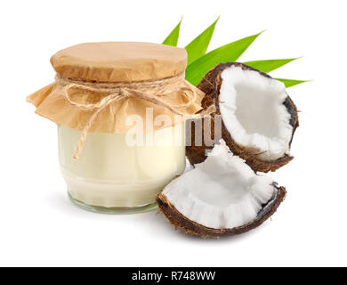 Jar of coconut oil and fresh coconuts isolated Stock Photo