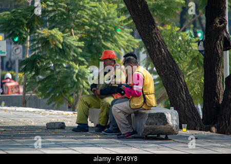 Three builders taking a break from work in Mexico City, Mexico Stock Photo