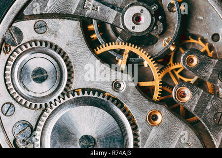 Close-Up Of Old Clock Watch Mechanism. Retro Clockwork Watch With Gray And Golden Gearwheels Gears. Vintage Movement Mechanics Stock Photo