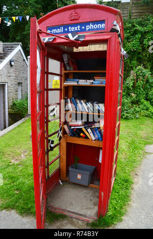 Books in a phone box at Gorren Haven, Cornwall, UK Stock Photo