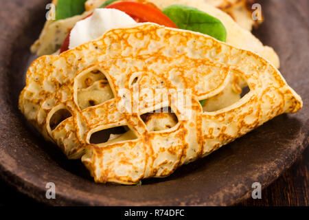 Pancakes sutffed with ham, cheese, tomatoes and spinach Stock Photo