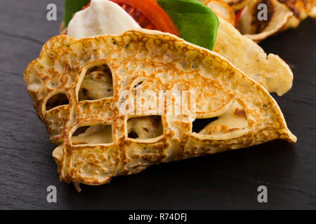 Pancakes sutffed with ham, cheese, tomatoes and spinach Stock Photo