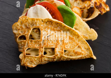 Pancakes sutffed with ham, cheese, tomatoes and spinach Stock Photo
