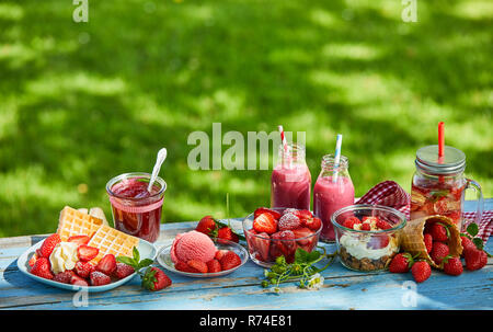 Fresh, vibrant summer strawberry desserts picnic table Stock Photo