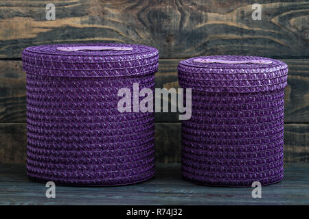 Purple Knitted Baskets on Blue Wooden Background Stock Photo