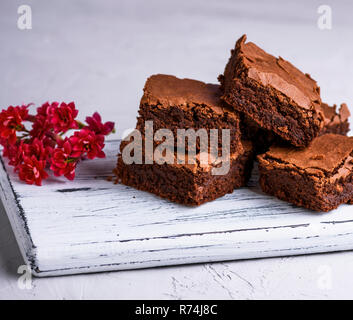 pile of square slices of baked brownie pie Stock Photo