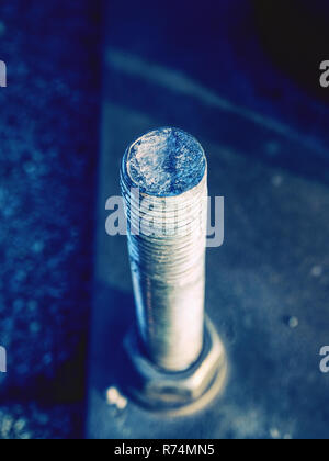 Detail of bolts. Steel plate based on anchor bolts on the concrete pillar. Stock Photo