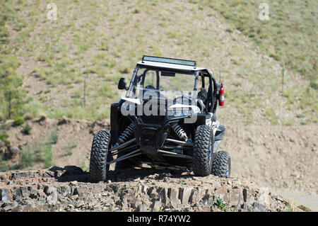 A 4x4 vehicle on a rock in Utah desert. Stock Photo