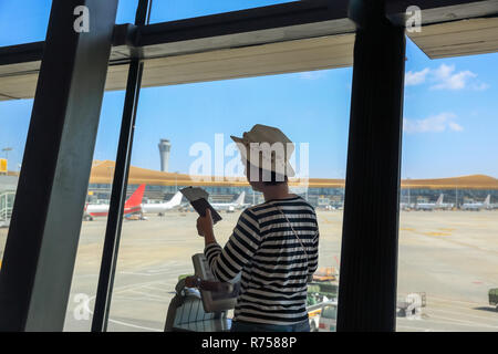 Passenger finding her boarding gate at Kunming Changshui International Airport  ,Yunnan, China. Stock Photo