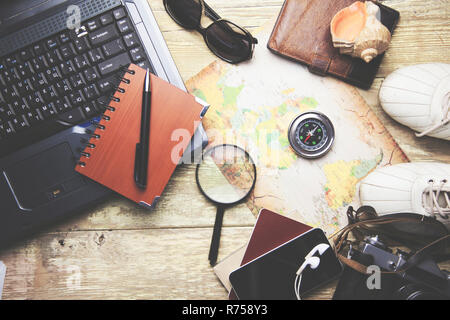 notebook and traveling Items on the wooden table Stock Photo