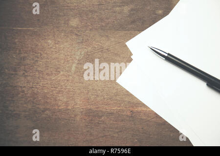 papers and pen on working wooden  table Stock Photo