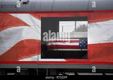 The flag draped casket of former president George H.W. Bush lies in repose inside a special Union Pacific funeral train December 6, 2018 in Spring, Texas. Bush, the 41st President, will be transported to his burial site at his presidential library in Texas A&M University by locomotive 4141. Stock Photo