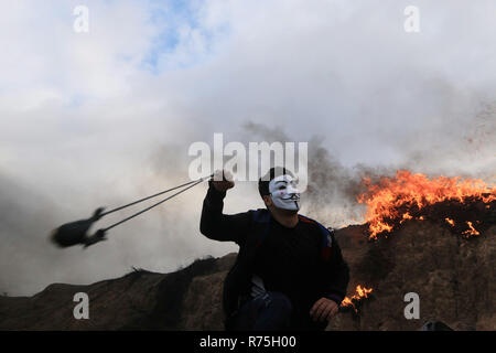 Bureij, Gaza Strip. 7th Dec, 2018. Palestinian protesters gather during clashes with Israeli troops in tents protest where Palestinians demand the right to return to their homeland at the Israel-Gaza border, in al-Bureij in the center of Gaza Strip. Credit: Mahmoud Khattab/APA Images/ZUMA Wire/Alamy Live News Stock Photo