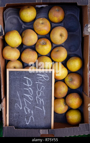 Box of Russet Apples outside fruit shop Stock Photo