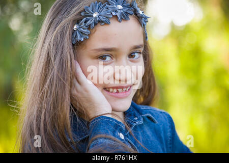 Cute Young Mixed Race Girl Portrait Outdoors. Stock Photo