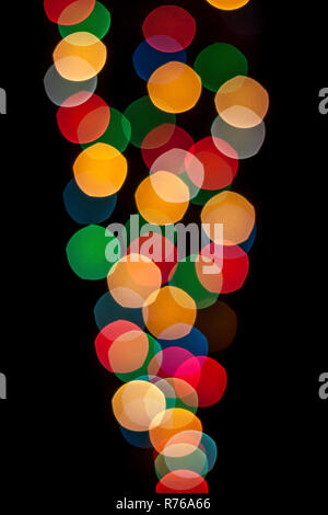 Cone shaped lights with different colors defocused and isolated on black background. Stock Photo