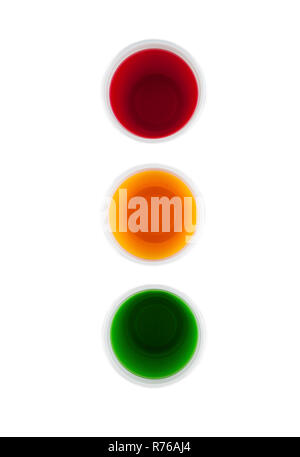 Plastic cups filled with different collored water and arranged as a traffic lights Stock Photo