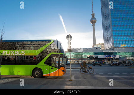 Flixbus long distance bus coach on Alexandersrasse Berlin with the Berlin Television Tower Berlin Fernsehturm Fernseh Tower on Alexanderplatz Stock Photo