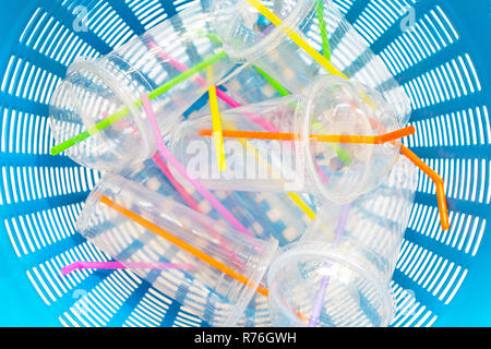 Plastic cups with straws in waste basket. Stock Photo