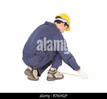 Young worker in unifrom with tape measure isolated on white Stock Photo