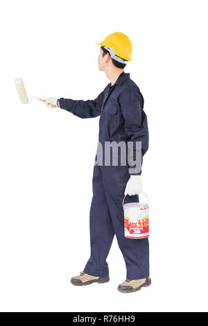 Worker in uniform using paint roller is painting invisible wall Stock Photo