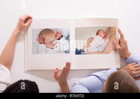 Couple Looking At Baby's Photo Album Stock Photo