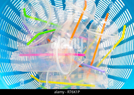 Plastic cups with straws in waste basket. Stock Photo