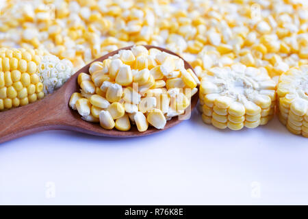 Corn seeds and ripe corn cobs on  white background. Stock Photo