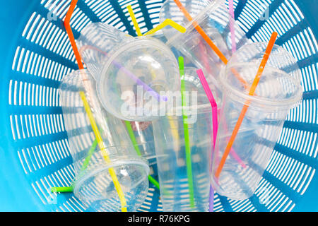 Plastic cups with straws in waste basket. Stock Photo