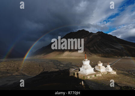 Double rainbows and overcast rainy sky and pagodas in Zanskar valley, India Stock Photo
