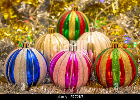 Festive balloons on bokeh background from shiny tinsel and shimmering colored garland. Scene for the New Year or Christmas Stock Photo