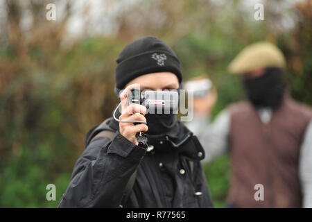 Hunt saboteurs filming hunters Stock Photo