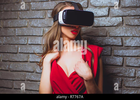 girl in red dress virtual glasses vr. Stock Photo