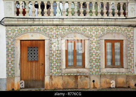 TAVIRA, PORTUGAL - NOVEMBER 20, 2018: Close-up on a typical house facade with patterned tiles (azulejos) inside the old town of Tavira Stock Photo