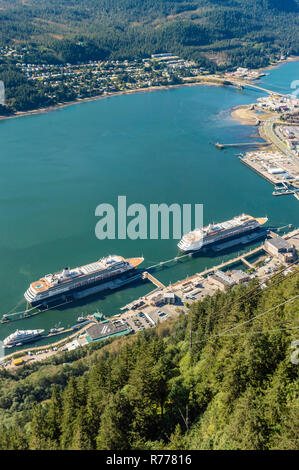 Downtown Alaska State capital of Juneau and cruise ship port with two ships docked, aerial view from Mount Roberts cable tram. Juneau, Alaska, USA. Stock Photo