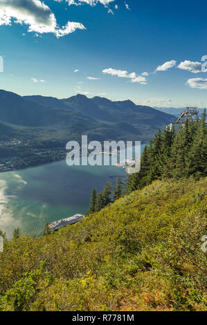 Aerial North facing view of Gastineau Channel from Mount Roberts on a clear, bright sunny day. Juneau, Alaska, USA. A cruise ship can be seen in port. Stock Photo